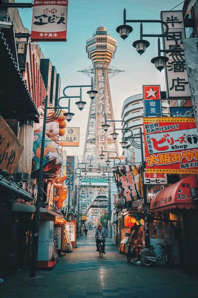 Tsūtenkaku Tower towering over the retro Shinsekai neighborhood street in Osaka, Japan for Spectrum of the Seas.